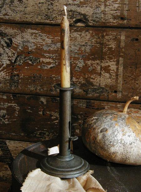 An early 19th century brass hog scraper candlestick in Antique