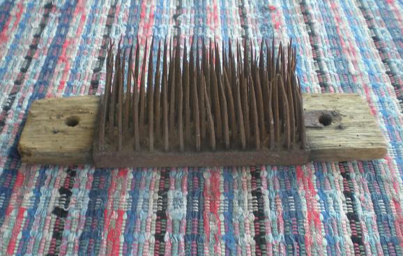 Hatchel (most likely actually a wool comb). 18th century. Iron spikes on a  wood base with a worked handle. 13…
