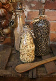 Primitive Riser with Three Old Glass Bottles and Wooden Spoon Gathering